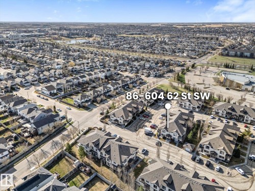 Aerial perspective showcasing a residential community with multi-story buildings and individual houses - 86 604 62 Street, Edmonton, AB - Outdoor With View