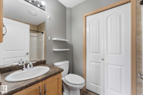 Carpeted staircase featuring a white handrail and light gray wall paint - 86 604 62 Street, Edmonton, AB - Indoor Photo Showing Other Room