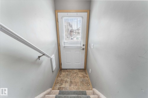 Spacious room featuring vaulted ceilings, light gray wall paint, and a large window with blinds - 86 604 62 Street, Edmonton, AB - Indoor Photo Showing Other Room