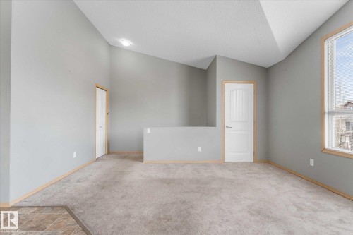 Open concept living area featuring a kitchen with light wood cabinetry, black appliances, and a tiled backsplash - 86 604 62 Street, Edmonton, AB - Indoor Photo Showing Other Room