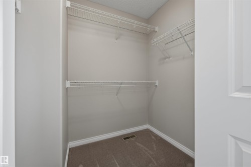 Walk-in closet in the Primary Bedroom. - 20813 96A Avenue, Edmonton, AB - Indoor With Storage