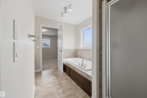 Ensuite 4-PC bath off the primary bedroom with in-floor heating. - 20813 96A Avenue, Edmonton, AB - Indoor Photo Showing Bathroom