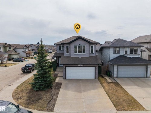 Contemporary two-story home featuring gray siding with white trim accents and a dark shingle roof - 20813 96A Avenue, Edmonton, AB - Outdoor With Facade