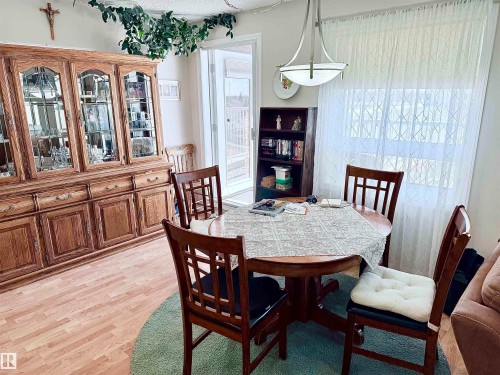 Dining area featuring wood-finish flooring and a contemporary overhead light fixture - 410 9926 100 Avenue, Fort Saskatchewan, AB - Indoor Photo Showing Dining Room