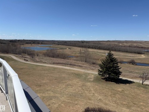 Expansive natural landscape featuring multiple ponds and paved walking paths - 410 9926 100 Avenue, Fort Saskatchewan, AB - Outdoor With View