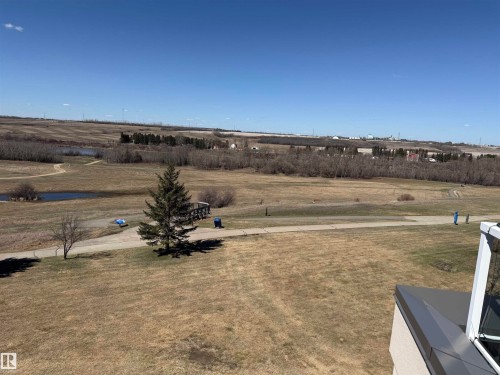 Expansive landscape featuring natural terrain, distant water features, and a clear horizon - 410 9926 100 Avenue, Fort Saskatchewan, AB - Outdoor With View