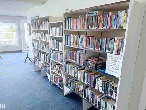 Extensive built-in shelving with multiple rows, light-toned finish, and varied compartment sizes - 410 9926 100 Avenue, Fort Saskatchewan, AB - Indoor