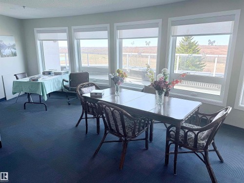 Curved wall of windows offering expansive outdoor views - 410 9926 100 Avenue, Fort Saskatchewan, AB - Indoor