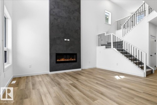 1150 Gyrfalcon Crescent, Edmonton, AB - Indoor Photo Showing Other Room With Fireplace