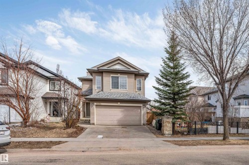Two-story residence featuring light brown siding and a dual-car attached garage - 1431 Hodgson Way, Edmonton, AB - Outdoor With Facade