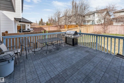 Spacious patio featuring dark gray paver flooring and a wooden railing - 1431 Hodgson Way, Edmonton, AB - Outdoor With Deck Patio Veranda