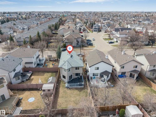 Two-story residential property featuring a multi-level deck, fenced backyard, and a detached storage shed - 1431 Hodgson Way, Edmonton, AB - Outdoor With View