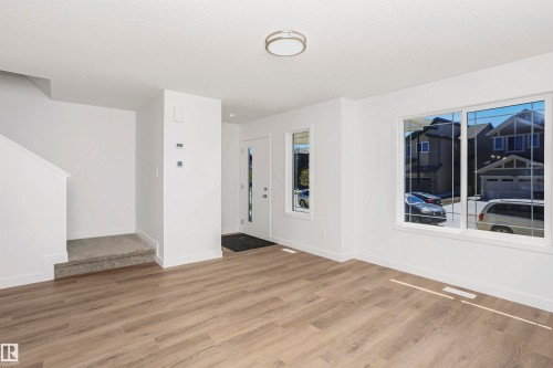 Bright living area with wood-finish flooring and white baseboards - 9552 Carson Bend Bend, Edmonton, AB - Indoor Photo Showing Other Room