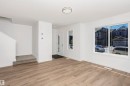 Bright living area with wood-finish flooring and white baseboards - 9552 Carson Bend Bend, Edmonton, AB  - Indoor Photo Showing Other Room 