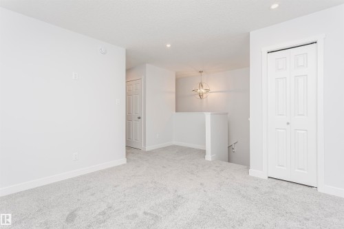 Carpeted interior space featuring white walls and trim - 9564 Carson Bend Bend, Edmonton, AB - Indoor