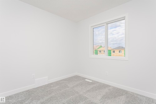 Light-filled interior space with a window featuring white trim - 9564 Carson Bend Bend, Edmonton, AB - Indoor Photo Showing Other Room
