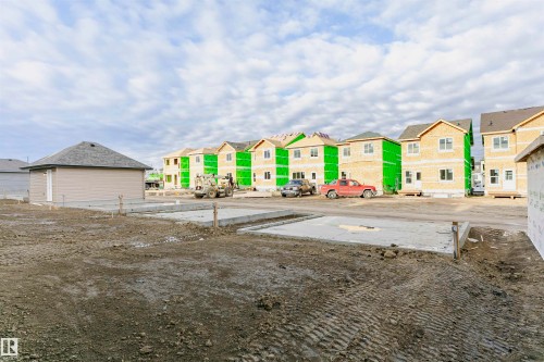 New construction foundations in place, with multiple framed homes in various stages of completion - 9564 Carson Bend Bend, Edmonton, AB - Outdoor
