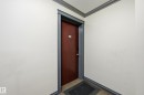 Entryway featuring a solid door with dark trim, contrasting against light-colored walls - 105 7204 81 Avenue, Edmonton, AB  - Indoor Photo Showing Other Room 
