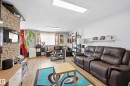 Living area featuring wood-finish flooring, a stone-accented wall, white walls, and recessed lighting - 105 7204 81 Avenue, Edmonton, AB  - Indoor Photo Showing Living Room 