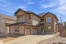 Stucco exterior with stone accents and a multi-level design - 3105 65 Street, Beaumont, AB  - Outdoor With Facade 