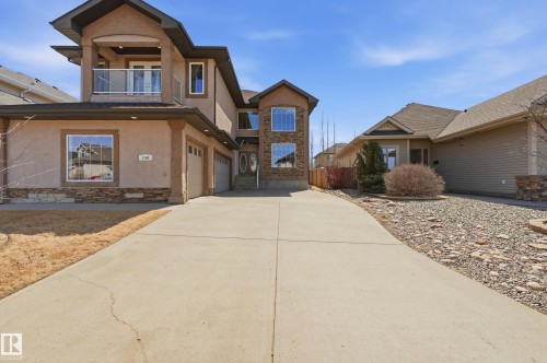 Stucco exterior with stone accents and a two-car garage - 3105 65 Street, Beaumont, AB - Outdoor With Facade
