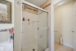Shower enclosure featuring clear glass sliding doors and a built-in shower niche - 