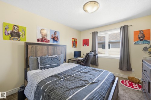Bedroom featuring light-toned walls and a single window with dark gray drapes - 3105 65 Street, Beaumont, AB - Indoor Photo Showing Bedroom