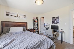 Bedroom featuring light-colored walls and carpeted flooring - 