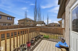 Wood-finish deck with a perimeter railing overlooking a private fenced yard - 