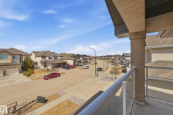 Exterior balcony with glass panel railing and stucco column - 