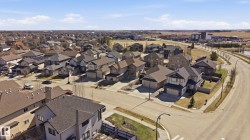 Aerial perspective showcasing a residential development with varied architectural styles and a curved street layout - 