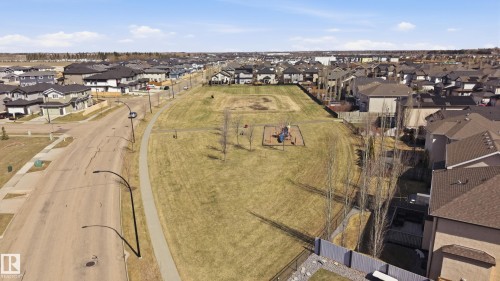 Expansive community green space featuring a play structure - 3105 65 Street, Beaumont, AB - Outdoor With View