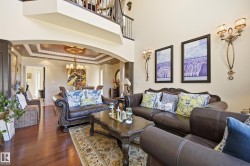 Hardwood-finish flooring throughout, featuring an arched entryway with detailed ceiling molding - 