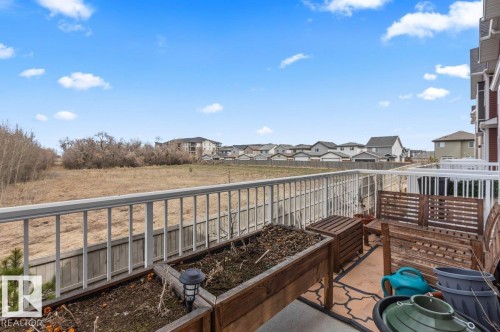 Outdoor deck featuring white metal railings, a concrete surface, and a patterned outdoor rug - 21 979 Crystallina Nera Way, Edmonton, AB - Outdoor With Balcony