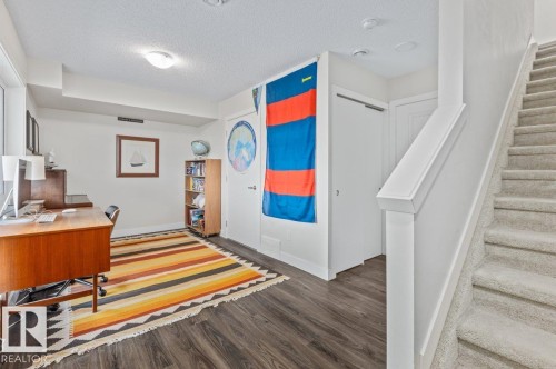 Versatile room featuring wood-finish flooring, white walls, and a recessed ceiling light - 21 979 Crystallina Nera Way, Edmonton, AB - Indoor Photo Showing Other Room