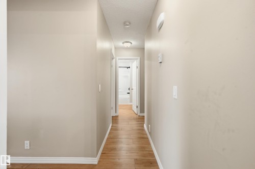 Hallway featuring wood-finish flooring, light neutral wall paint, and recessed lighting - 1729 65 Street, Edmonton, AB - Indoor Photo Showing Other Room