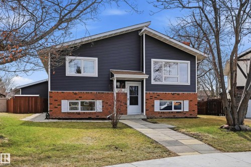 Split-level residence featuring dark siding and a red brick facade - 1729 65 Street, Edmonton, AB - Outdoor