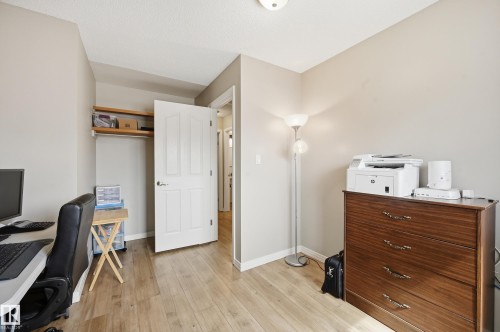 Light wood-finish flooring with neutral wall tones - 1729 65 Street, Edmonton, AB - Indoor Photo Showing Office