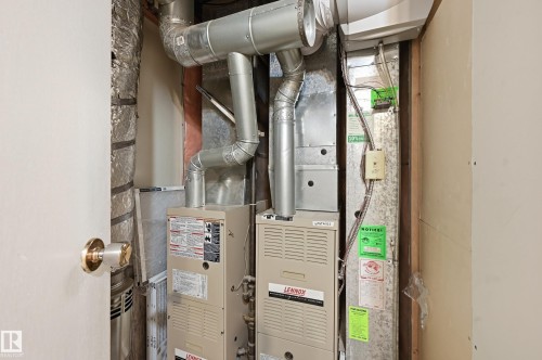Mechanical room featuring a Lennox furnace, an additional furnace unit, and extensive ductwork - 1729 65 Street, Edmonton, AB - Indoor Photo Showing Basement