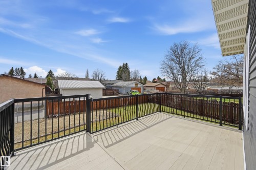 Spacious outdoor deck with composite decking, black metal railings, and a privacy fence - 1729 65 Street, Edmonton, AB - Outdoor With Exterior