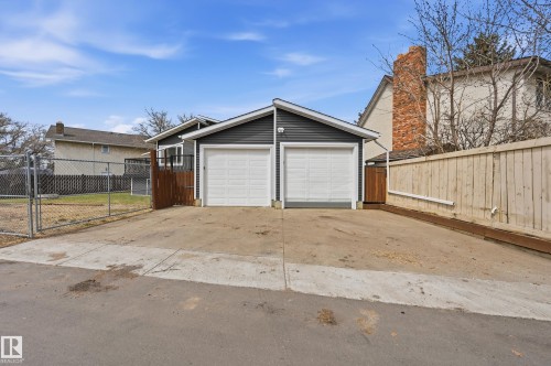 Detached two-car garage with dark gray siding and white garage doors - 1729 65 Street, Edmonton, AB - Outdoor With Exterior