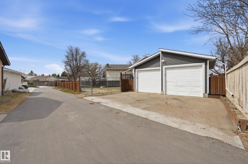Detached two-car garage with gray siding and white garage doors - 1729 65 Street, Edmonton, AB - Outdoor With Exterior