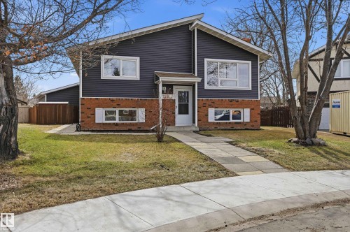 Split-level residence featuring dark siding and brick veneer - 1729 65 Street, Edmonton, AB - Outdoor