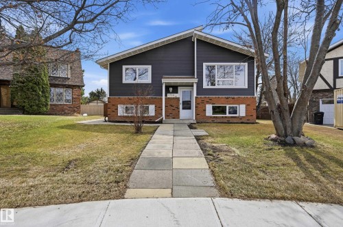 Split-level residence featuring dark horizontal siding and brick veneer - 1729 65 Street, Edmonton, AB - Outdoor With Facade