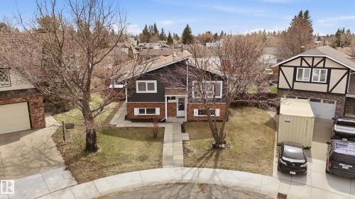 Split-level residence featuring brick and dark-toned siding with white window trim - 1729 65 Street, Edmonton, AB - Outdoor
