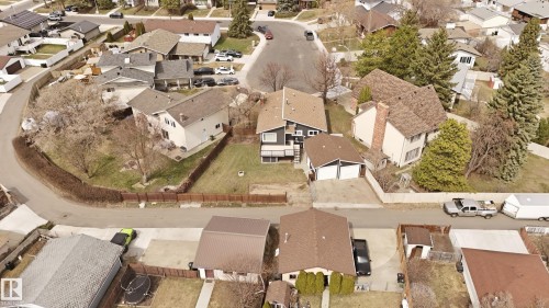 Aerial perspective of a suburban residential neighborhood featuring multiple homes with pitched roofs and varying exterior finishes - 1729 65 Street, Edmonton, AB -  With View