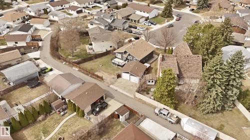 Residential neighborhood featuring a curvilinear street layout, mature evergreen and deciduous trees, and single-family homes with pitched roofs - 1729 65 Street, Edmonton, AB -  With View