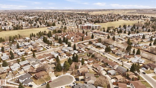 Expansive residential neighborhood featuring a mix of detached homes and multi-story buildings, bordered by open fields - 1729 65 Street, Edmonton, AB - Outdoor With View