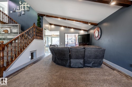Vaulted ceilings with exposed wood beams in this living area - 7 Doolan Place, St. Albert, AB - Indoor Photo Showing Other Room