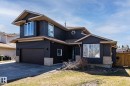 Two-story residence featuring dark horizontal siding, light soffits, and a brown asphalt shingle roof - 7 Doolan Place, St. Albert, AB  - Outdoor 